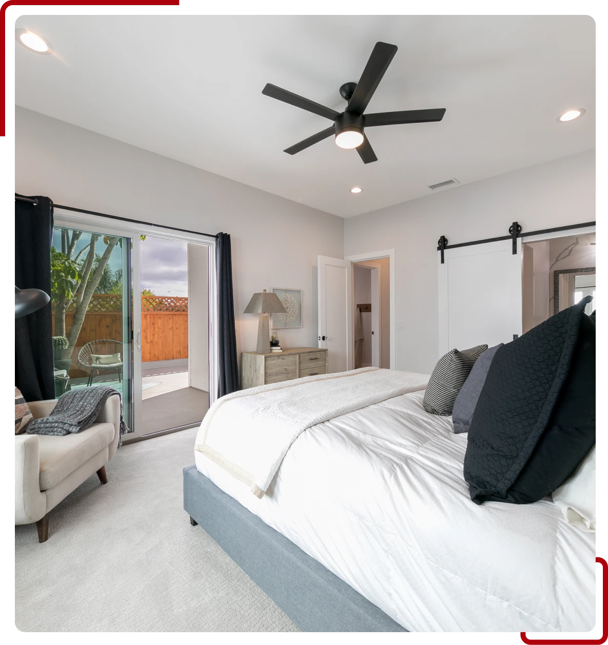 Cozy bedroom featuring black ceiling fan